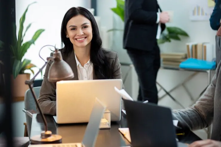 Salesforce developer working in an office on her laptop